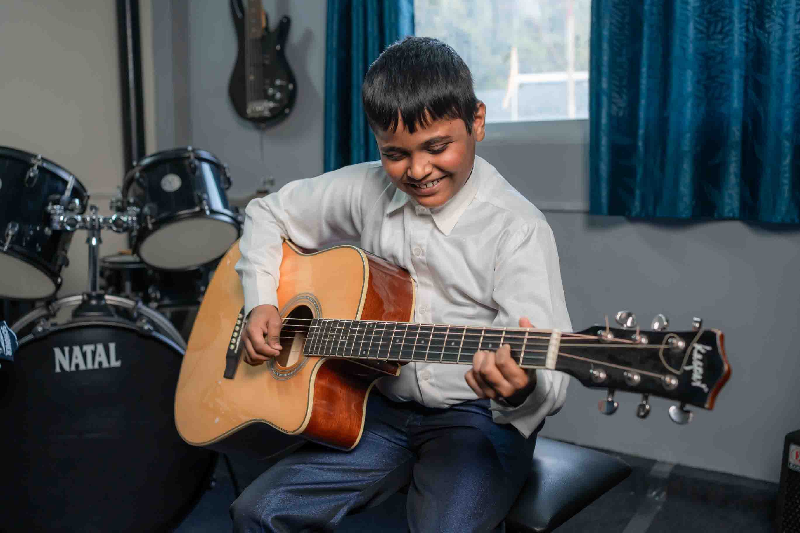 Student exploring guitar and drums