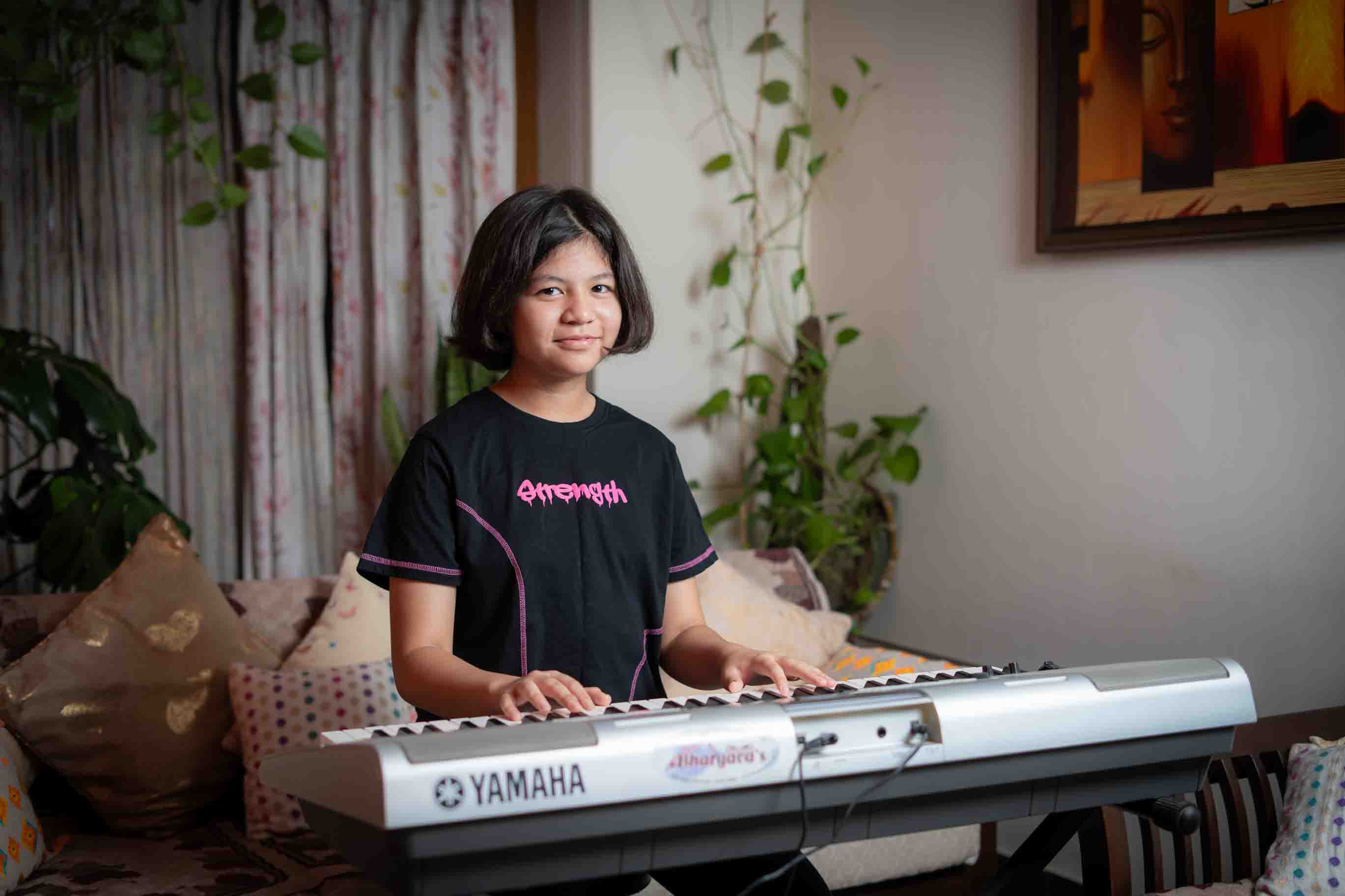 Young student playing keyboard